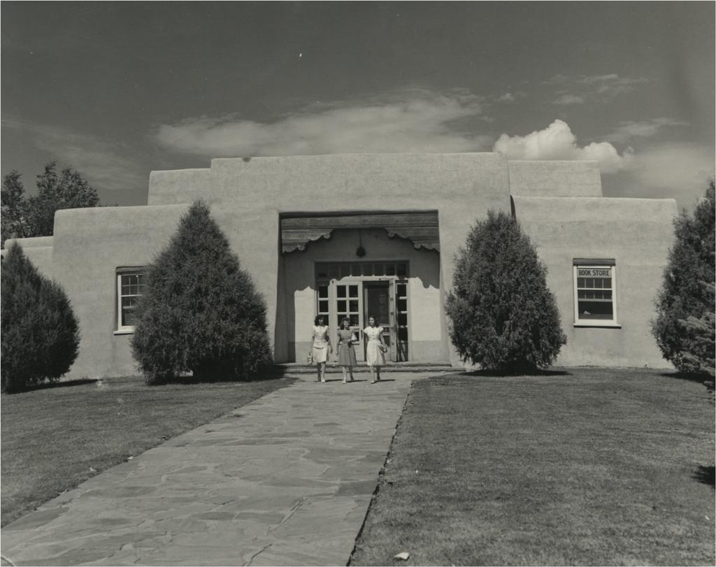 Three students leave the Student Union Building. A sign in the right window advertises the campus bookstore. Soon the campus would outgrow this building, and both the SUB and the bookstore would move. Source: Center for Southwest Research